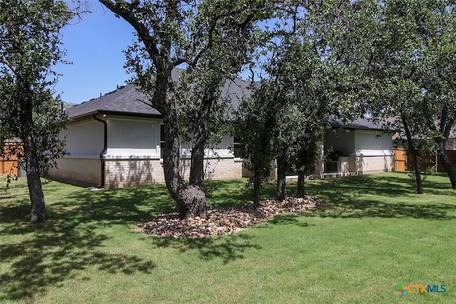 view of property exterior with a yard