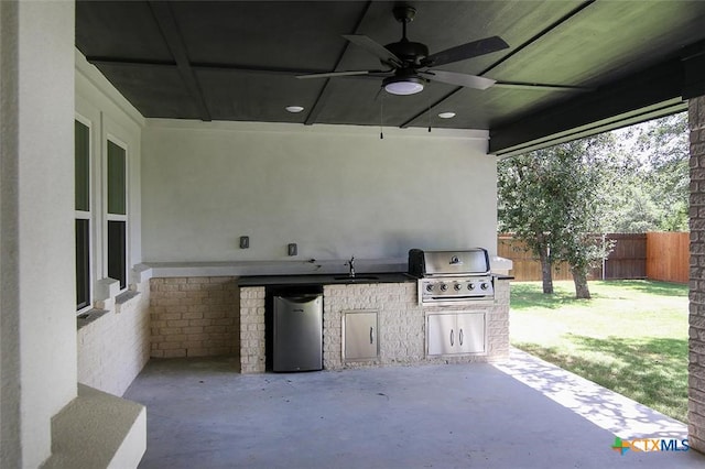 view of patio / terrace featuring a grill, area for grilling, sink, and ceiling fan