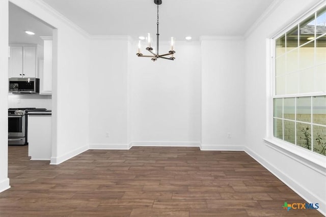 unfurnished dining area featuring a chandelier, crown molding, and dark hardwood / wood-style floors