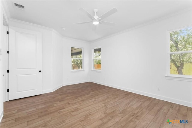 spare room with ceiling fan, light wood-type flooring, and crown molding