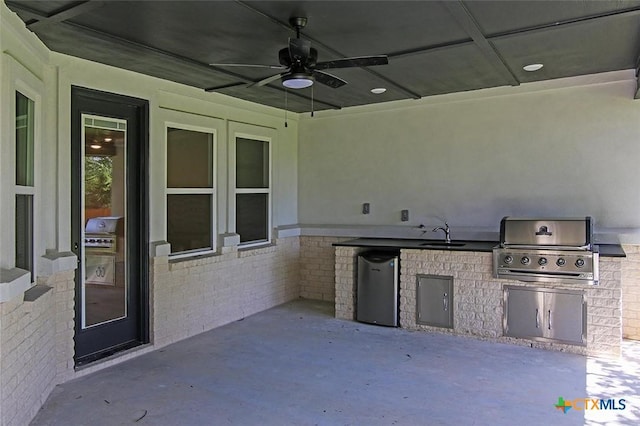 view of patio / terrace with exterior kitchen, ceiling fan, sink, and grilling area