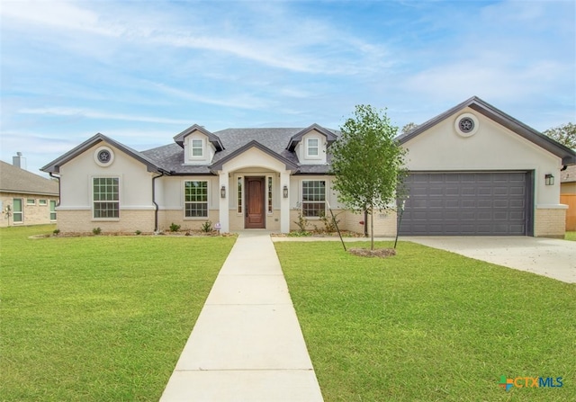 4113 Turning Leaf Dr, Nolanville, TX 76559 - view of front of house featuring a garage, brick siding, concrete driveway, a front lawn, and stucco siding