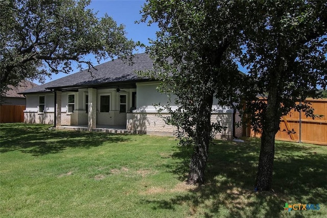 back of house featuring a yard