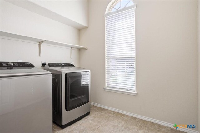 6231 Ambrose Cir, Temple, TX 76502 - washroom with washer and dryer and light tile patterned floors