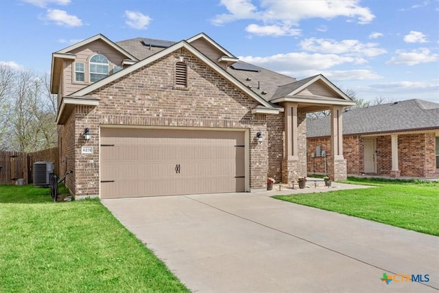 6231 Ambrose Cir, Temple, TX 76502 - view of front facade with brick siding, driveway, an attached garage, and roof mounted solar panels