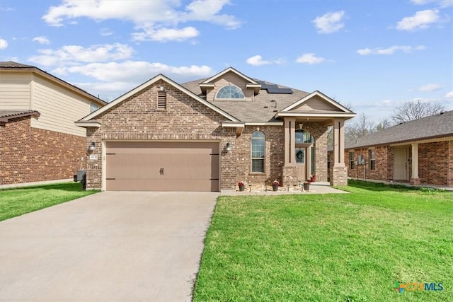 6231 Ambrose Cir, Temple, TX 76502 - traditional-style house with brick siding, a front lawn, a garage, concrete driveway, and solar panels