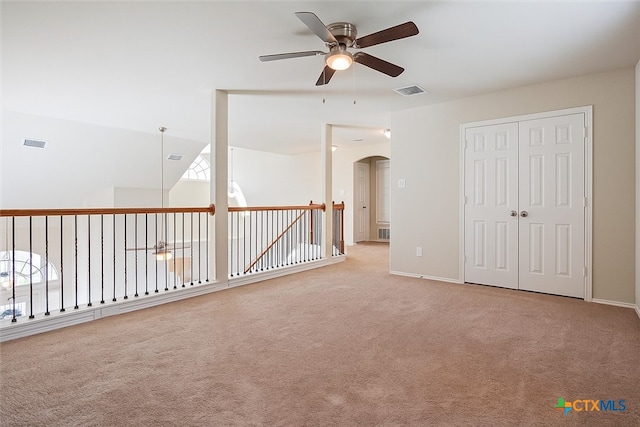 6231 Ambrose Cir, Temple, TX 76502 - empty room with ceiling fan, light colored carpet, and arched walkways