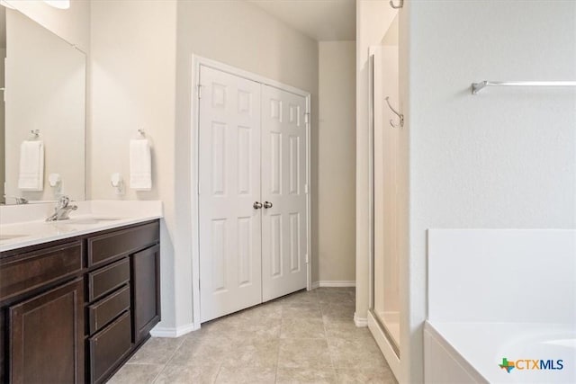 6231 Ambrose Cir, Temple, TX 76502 - full bathroom featuring double vanity, a garden tub, tile patterned floors, and a shower