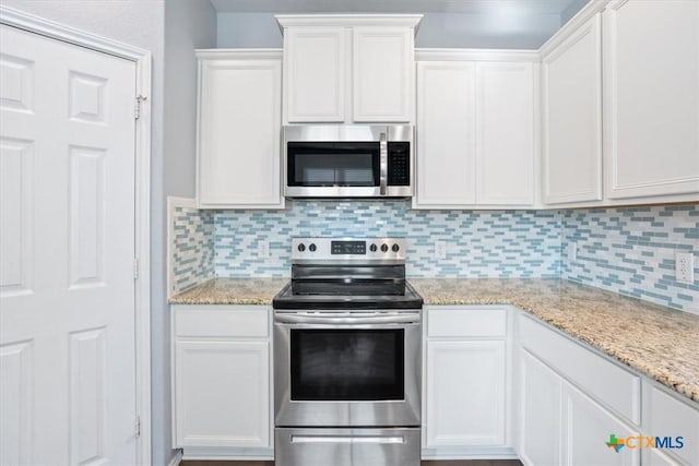 6231 Ambrose Cir, Temple, TX 76502 - kitchen with appliances with stainless steel finishes, white cabinets, tasteful backsplash, and light stone countertops