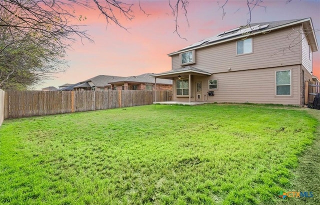 6231 Ambrose Cir, Temple, TX 76502 - rear view of house featuring a fenced backyard, roof mounted solar panels, and a patio