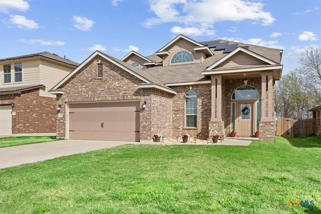 6231 Ambrose Cir, Temple, TX 76502 - traditional-style house with brick siding, driveway, a garage, and roof mounted solar panels
