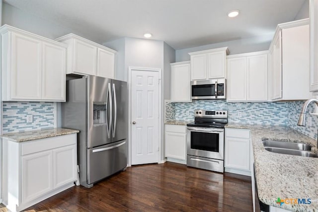 6231 Ambrose Cir, Temple, TX 76502 - kitchen featuring appliances with stainless steel finishes, white cabinetry, tasteful backsplash, and recessed lighting