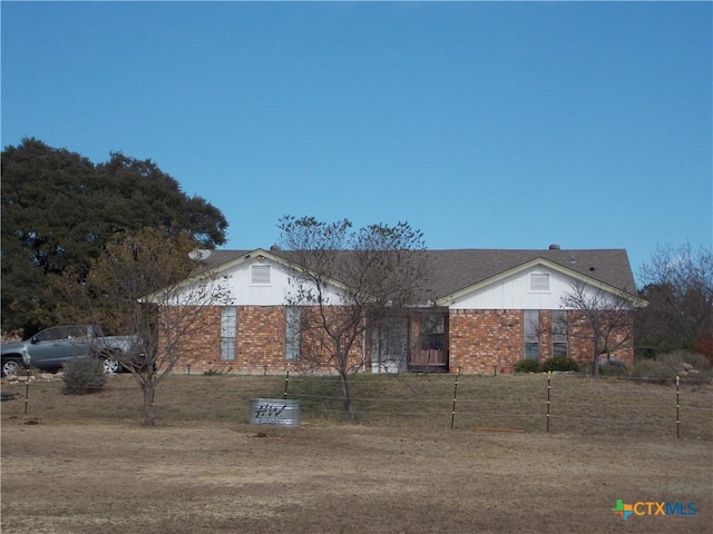 ranch-style house featuring brick siding