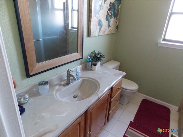 bathroom featuring tile patterned floors, plenty of natural light, toilet, and vanity