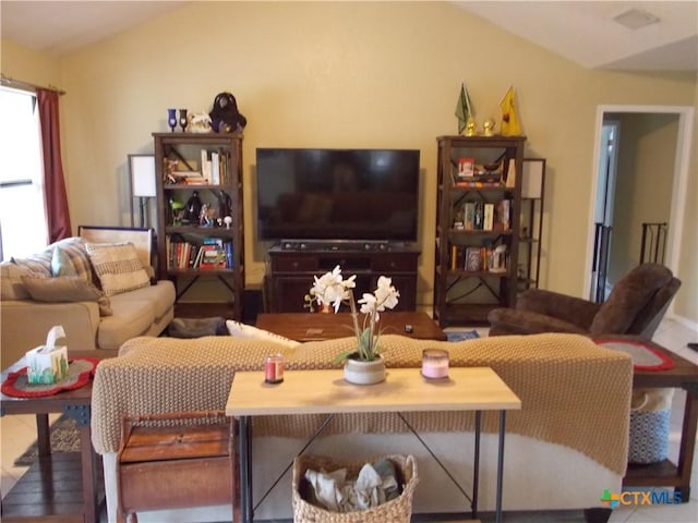 living area featuring lofted ceiling