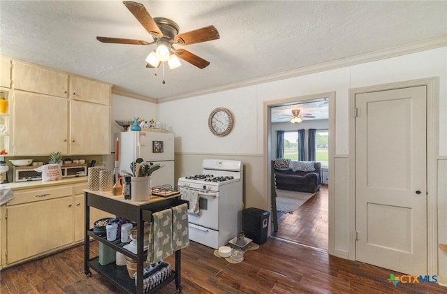 704 Maple St, Yoakum, TX 77995 - kitchen featuring white appliances, ceiling fan, light brown cabinetry, crown molding, and dark wood-type flooring
