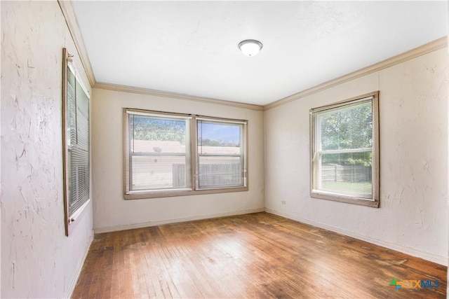 704 Maple St, Yoakum, TX 77995 - empty room with wood-type flooring and ornamental molding