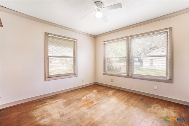 704 Maple St, Yoakum, TX 77995 - spare room featuring ornamental molding, light wood-style floors, and a ceiling fan
