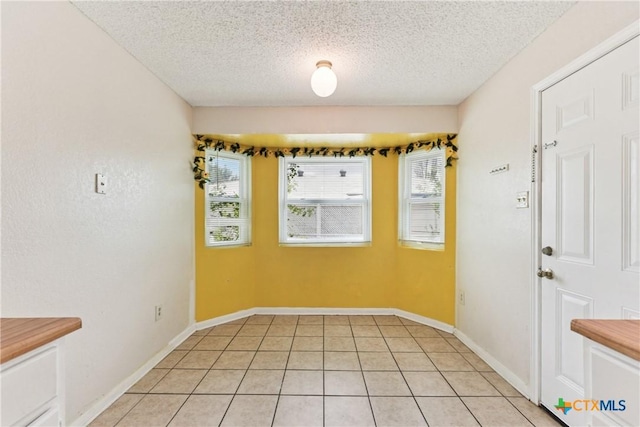 2601 Traverse Dr, Killeen, TX 76543 - unfurnished dining area with a textured ceiling and light tile patterned flooring