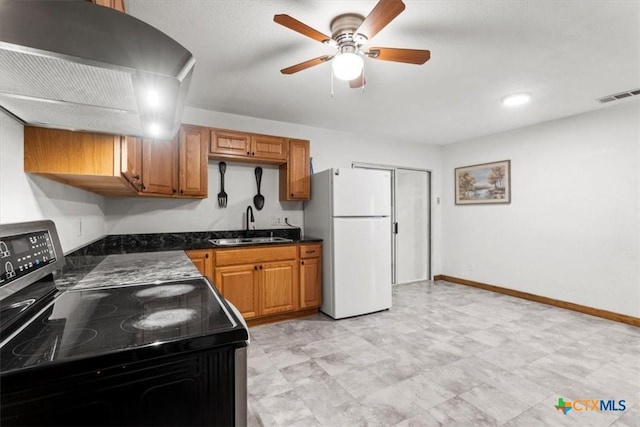 1102 S 5th St, Copperas Cove, TX 76522 - kitchen with freestanding refrigerator, electric range oven, wall chimney range hood, dark countertops, and ceiling fan