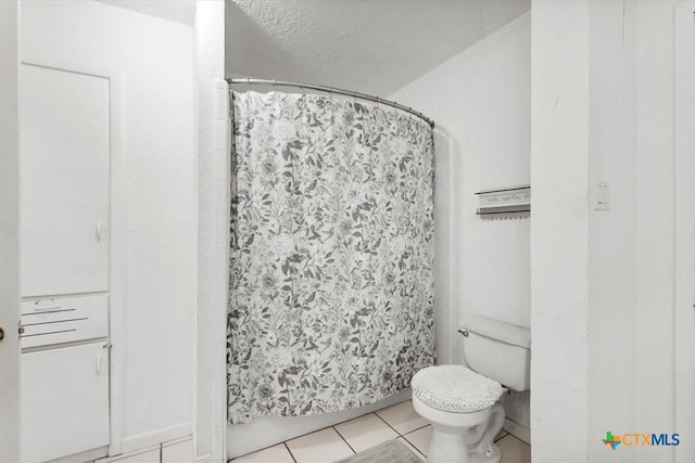 1102 S 5th St, Copperas Cove, TX 76522 - full bathroom with tile patterned flooring, curtained shower, and a textured ceiling