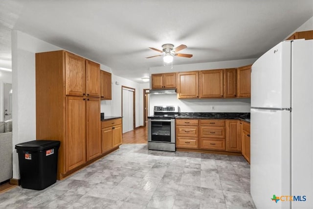 1102 S 5th St, Copperas Cove, TX 76522 - kitchen featuring freestanding refrigerator, stainless steel electric stove, under cabinet range hood, ceiling fan, and dark countertops