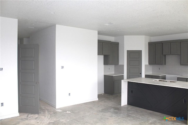 kitchen featuring decorative backsplash and a textured ceiling