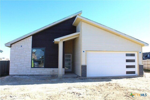 view of side of home featuring a garage