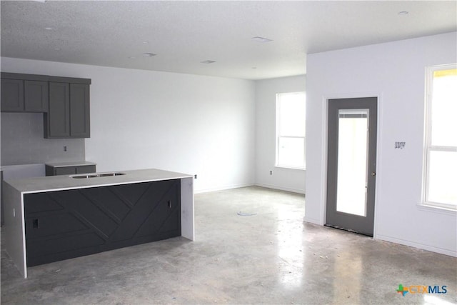 kitchen with plenty of natural light and tasteful backsplash