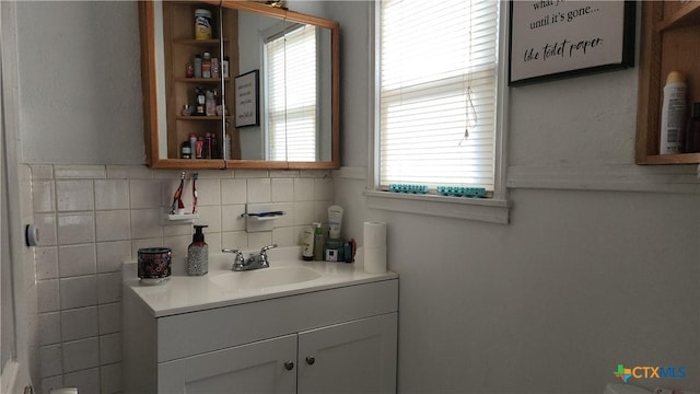 bathroom featuring vanity and tasteful backsplash