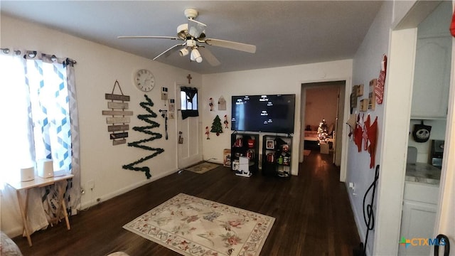 living room featuring ceiling fan and dark wood-type flooring