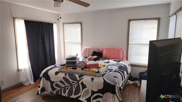 bedroom with wood-type flooring and ceiling fan