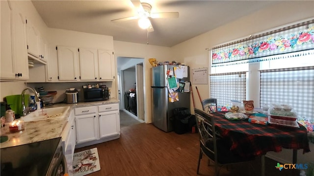 kitchen with dark wood-type flooring, white cabinets, sink, ceiling fan, and stainless steel fridge