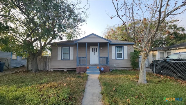 bungalow-style house with a front lawn