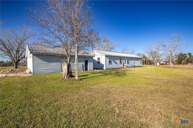 back of house with a lawn