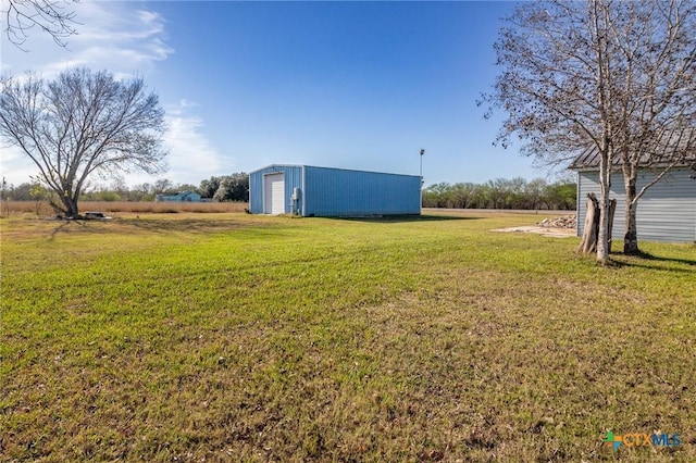 view of yard featuring an outdoor structure and a garage