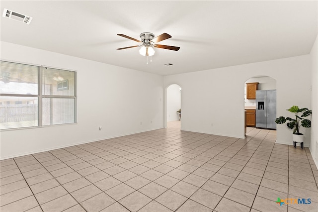 3908 Fieldcrest Dr, Killeen, TX 76549 - empty room featuring arched walkways, a ceiling fan, and light tile patterned floors