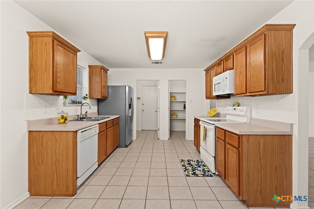 3908 Fieldcrest Dr, Killeen, TX 76549 - kitchen featuring white appliances, light countertops, decorative backsplash, and brown cabinets