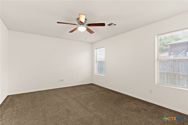3908 Fieldcrest Dr, Killeen, TX 76549 - unfurnished room featuring healthy amount of natural light, dark carpet, and a ceiling fan