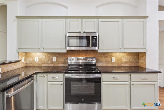 3306 Spring Canyon Rd, Belton, TX 76513 - kitchen with dark stone counters, appliances with stainless steel finishes, and tasteful backsplash