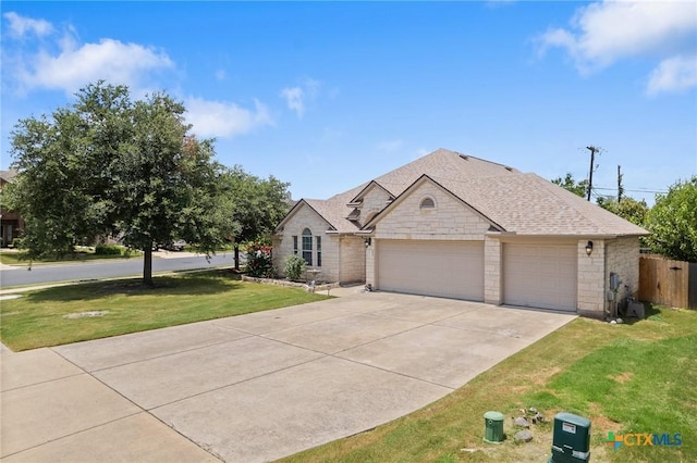 101 Payne Stewart Dr, Round Rock, TX 78664 - view of front of property featuring stone siding, a garage, driveway, and a shingled roof