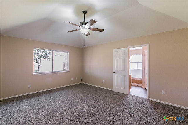 carpeted empty room featuring ceiling fan and lofted ceiling