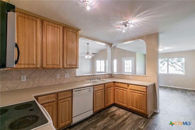 kitchen featuring dishwasher, sink, range, and dark hardwood / wood-style floors