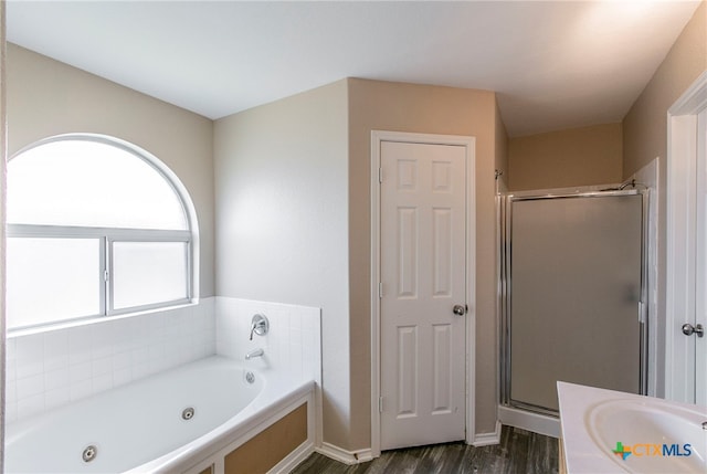 bathroom featuring independent shower and bath and hardwood / wood-style floors