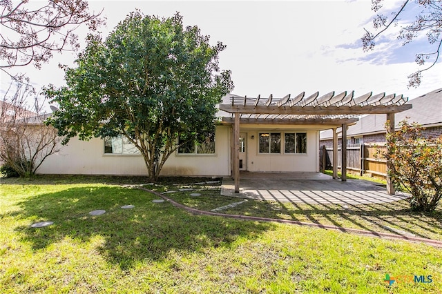 back of property featuring a patio area, a lawn, and a pergola