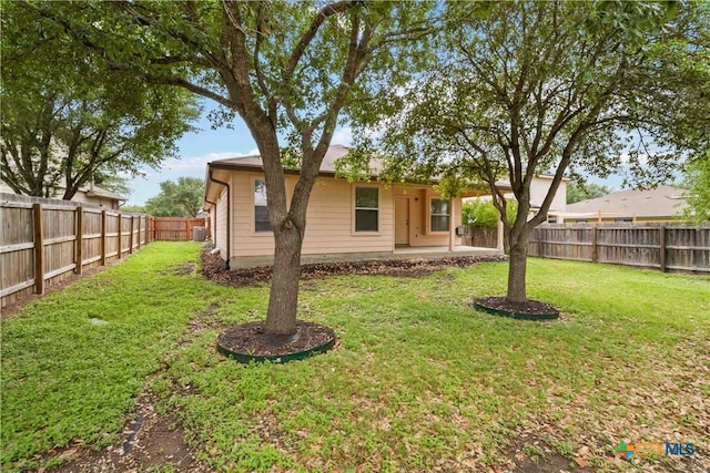exterior space featuring a front yard, a patio, and a fenced backyard