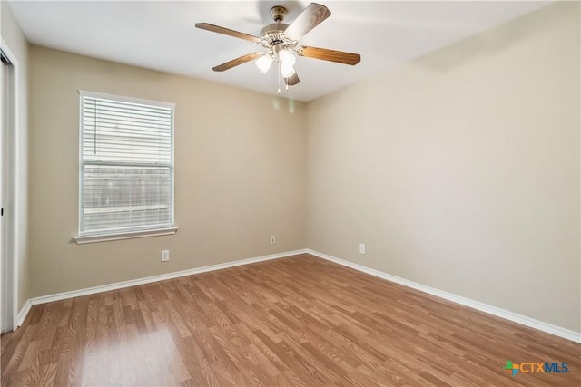 unfurnished room featuring baseboards, a ceiling fan, and light wood finished floors