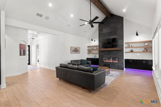 813 Eagle Heights Dr, Salado, TX 76571 - living room with a fireplace, beam ceiling, light wood-type flooring, ceiling fan, and a chandelier