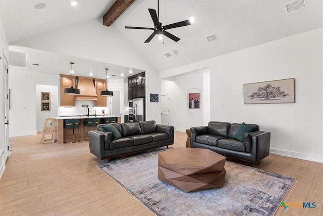 813 Eagle Heights Dr, Salado, TX 76571 - living area featuring light wood-type flooring, beamed ceiling, a ceiling fan, high vaulted ceiling, and baseboards