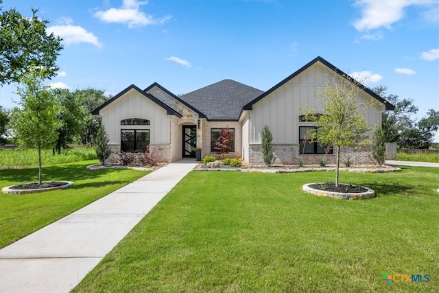 813 Eagle Heights Dr, Salado, TX 76571 - view of front of house with board and batten siding, a front yard, a shingled roof, and brick siding